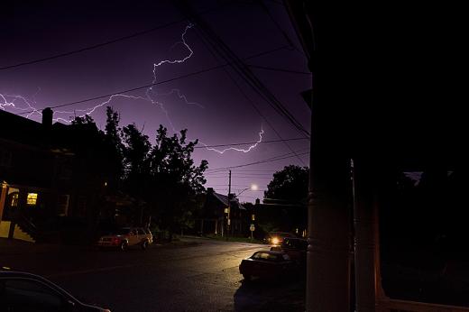A photo looking out at a lightning storm.