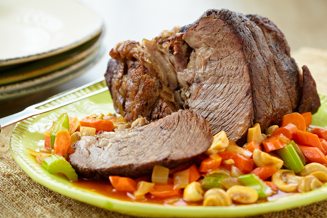 Beef roast well cooked on a succotash.