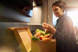 Woman unpacking meal kit box